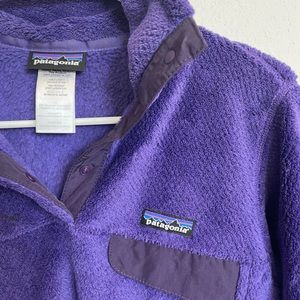 Purple Patagonia fleece quarter zip sweatshirt.